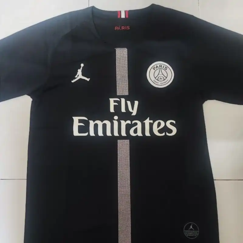 Football jersey photographed flat with collapsed neckline and no collar structure visible