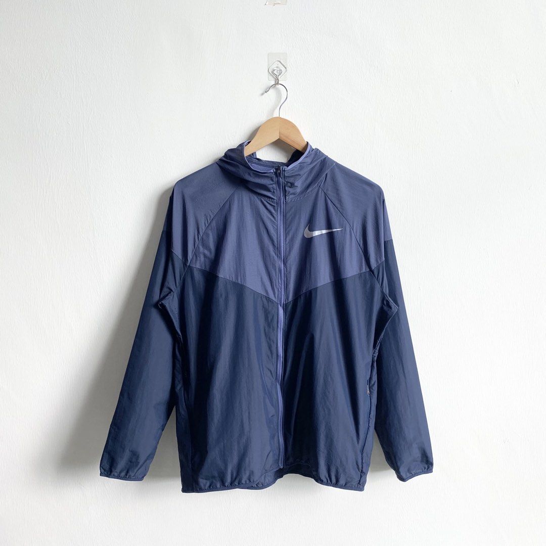 Hoodie jacket on a hanger against a plain background