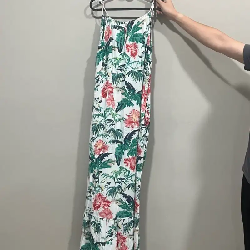 Dress hanging on hanger showing shapeless flat appearance with no garment dimension