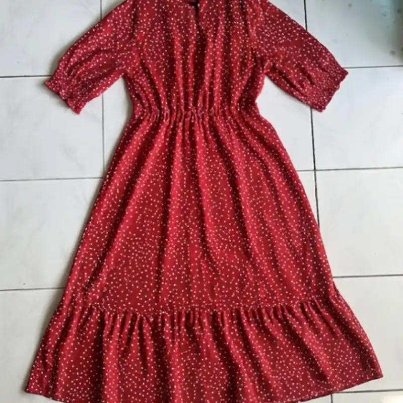 Red dress laid flat on tile floor