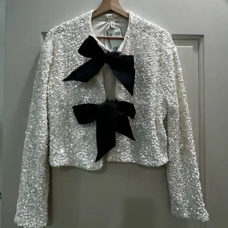 Jacket on hanger against uneven grey wall